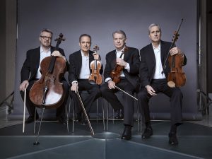 Members of the Emerson Quartet holding string instruments
