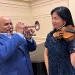 Rodney Marsalis and Elizabether Suh Lane pose with their trumpet and violin.
