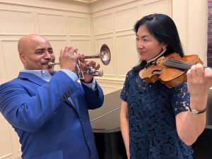 Rodney Marsalis and Elizabether Suh Lane pose with their trumpet and violin.